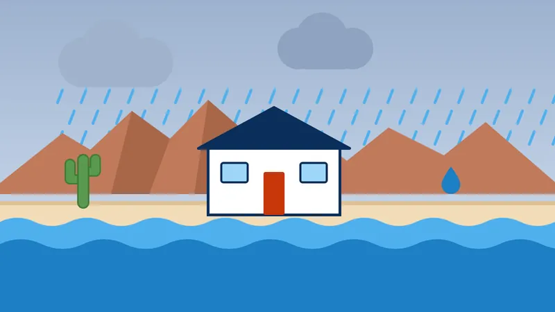 Floodwater rising around a house under a stormy sky with mountains behind